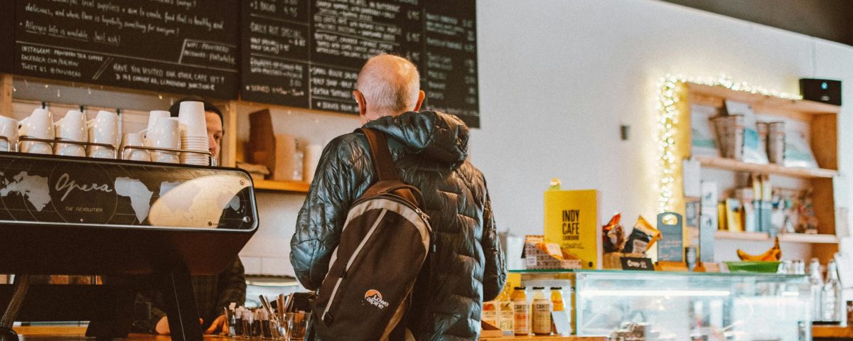 pexels-photo-1833399-1833399 A casual café setting with a customer ordering coffee at the counter.