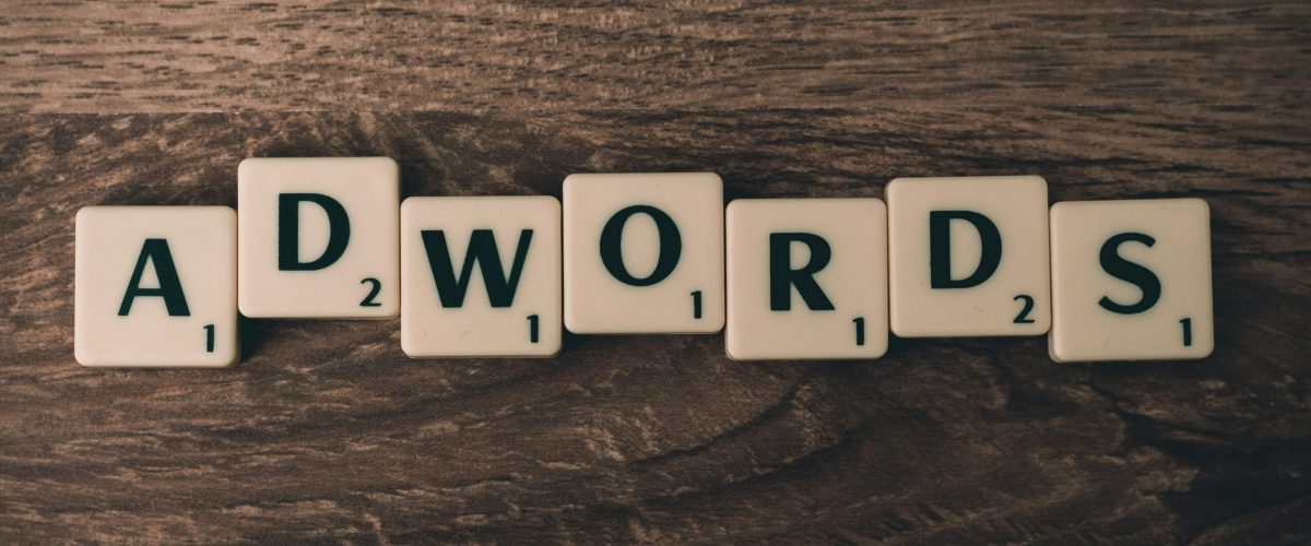 pexels-photo-267401-267401 Scrabble tiles spelling 'AdWords' on a wooden surface, symbolizing digital marketing concepts.